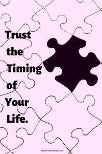 A picture of a pink puzzle missing a puzzle piece revealing a black background, quote "trust the timing of your life"