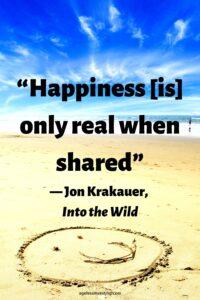 A picture of a smiley face drawn on a beach, with the headline: “Happiness [is] only real when shared” ― Jon Krakauer, Into the Wild "